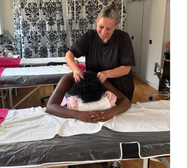Tutor demonstrating Indian head massage