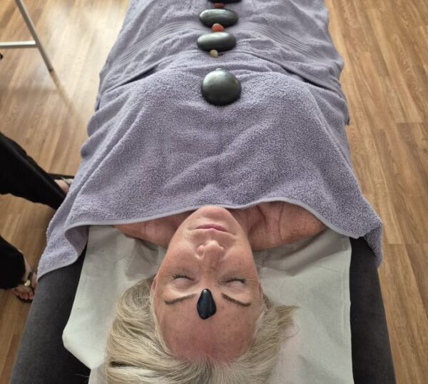 Hot stones placed along a client's back
