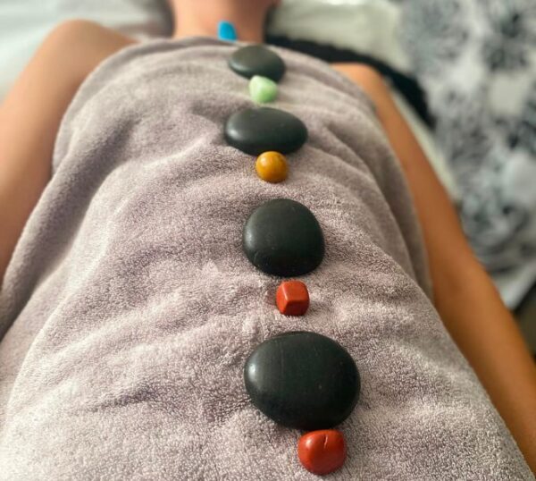 Hot stones and crystals placed along a client's spine