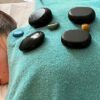 Massage stones laid out on a towel