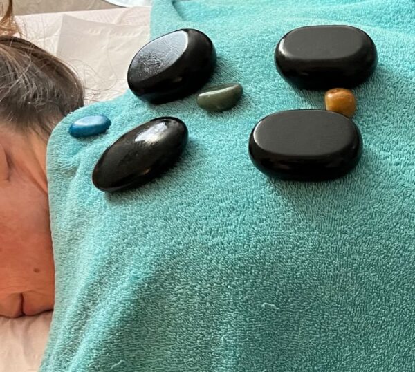 Massage stones laid out on a towel