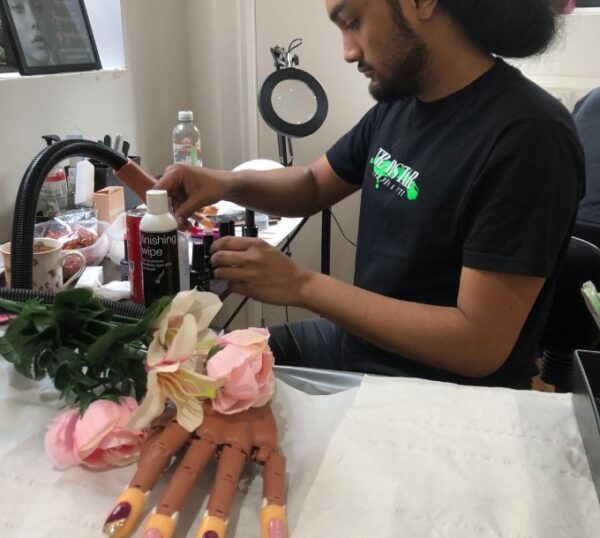 Student working at a nail training desk