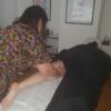 Student practising massage in a training room