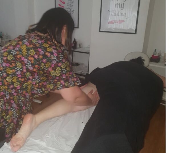 Student practising massage in a training room