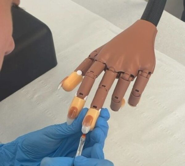 UV gel nail extensions on a practice hand