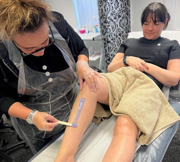 Students practising leg waxing on the Beginners Waxing Training Course