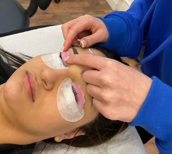 Student applying a lash lift shield