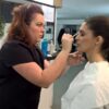 Make-up artist applying make-up to a model during training