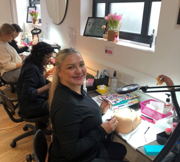 Lash students in a Beauty Academy training room
