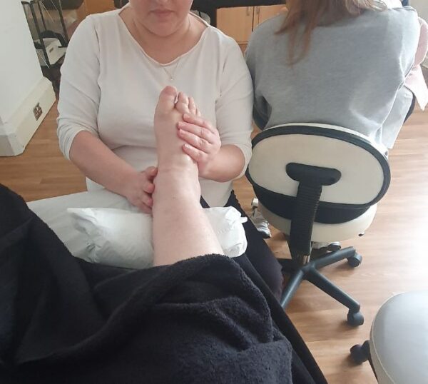 Students practising reflexology on each other