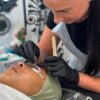 Student carrying out a lash lift in training