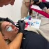 Students practising lash lifts in a training room