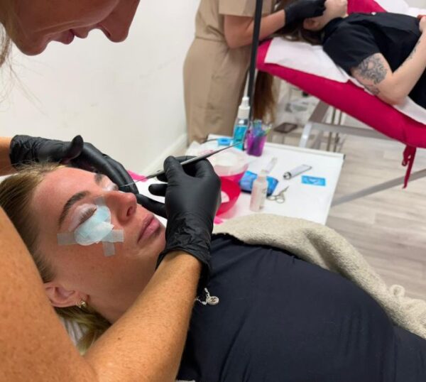 Students practising lash lifts in a training room