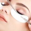 Classic eyelash extensions being applied with tweezers