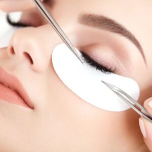Classic eyelash extensions being applied with tweezers