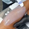 Warm wax being applied to a leg