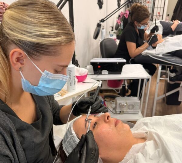 Students practising electrical facials during training