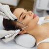 Client receiving an electrical facial with microcurrent probes