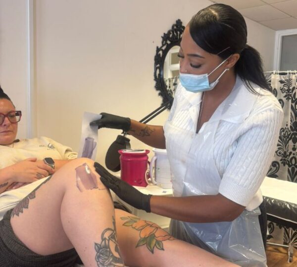 Student carrying out a waxing treatment