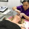 Tutor demonstrating a microdermabrasion facial