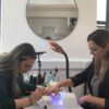 Students practising gel polish manicures