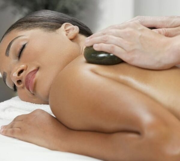 Client relaxing during a hot stone massage