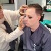 Make-up artist working on a model during training