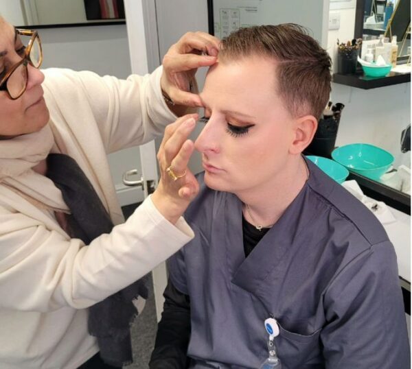 Make-up artist working on a model during training