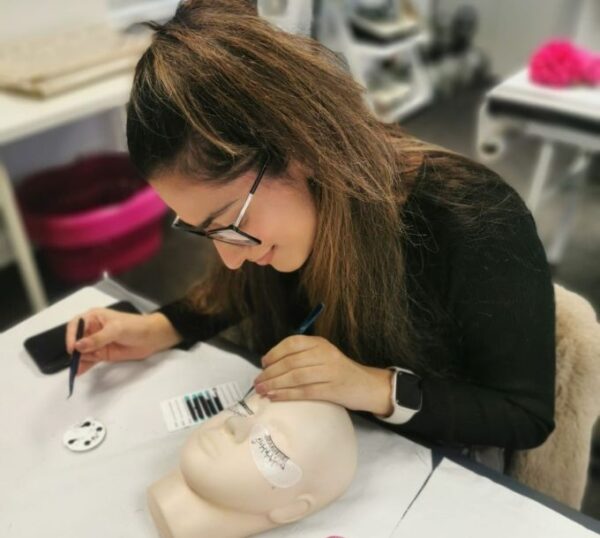 Student practising eyelash extensions during training