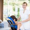 Smiling massage therapist with a client