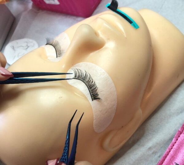 Russian volume lashes being applied to a training mannequin