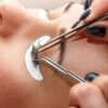 Russian volume lashes being applied with tweezers