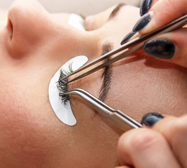 Russian volume lashes being applied with tweezers