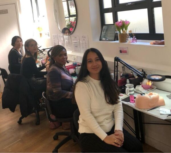 Lash students in a Beauty Academy training room