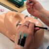 Lash extensions being applied to a practice mannequin