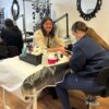 Students practising manicures in a training room