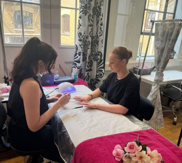 Students practising gel nails in a training room
