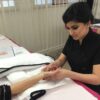 Student practising manicures during training