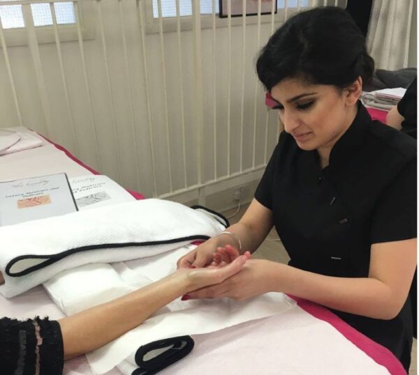 Student practising manicures during training