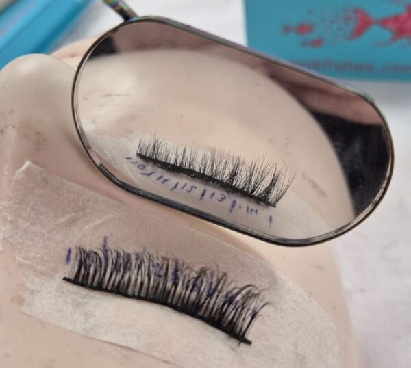 Lash extension fan held on a mirror