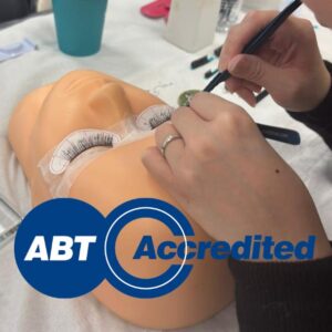 Student applying hybrid eyelash extensions during training