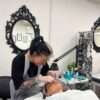 Student working in a Beauty Academy training room