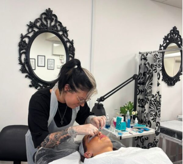 Student working in a Beauty Academy training room