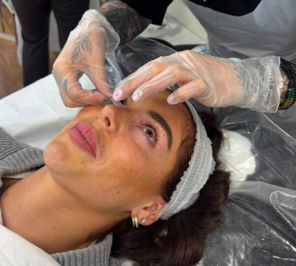 Brows being shaped during lash and brow training