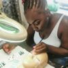 Student practising lash extensions under a magnifying lamp