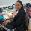 Smiling student with a practice mannequin head