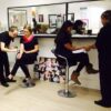 Make-up students and tutor in a Beauty Academy training room