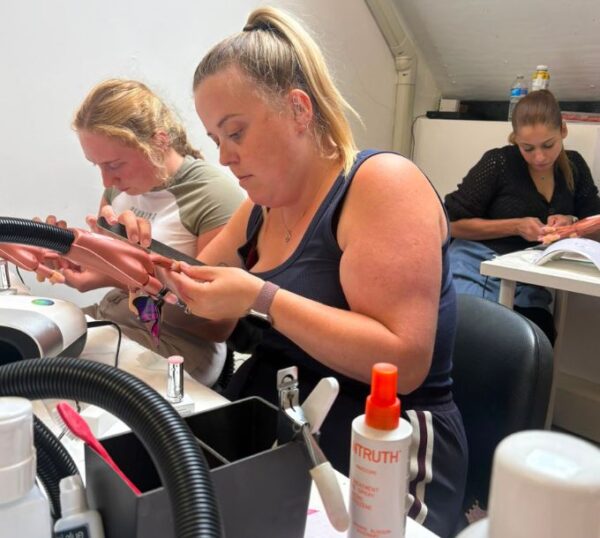 Students practising builder gel nails