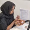 Student practising nails during a training course