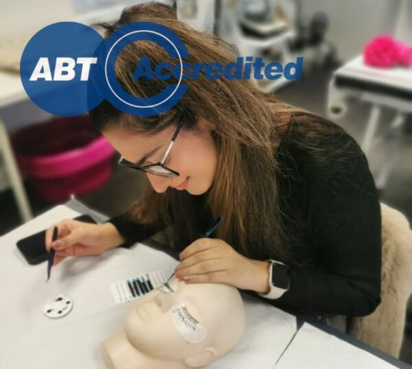 Student applying lash extensions during training
